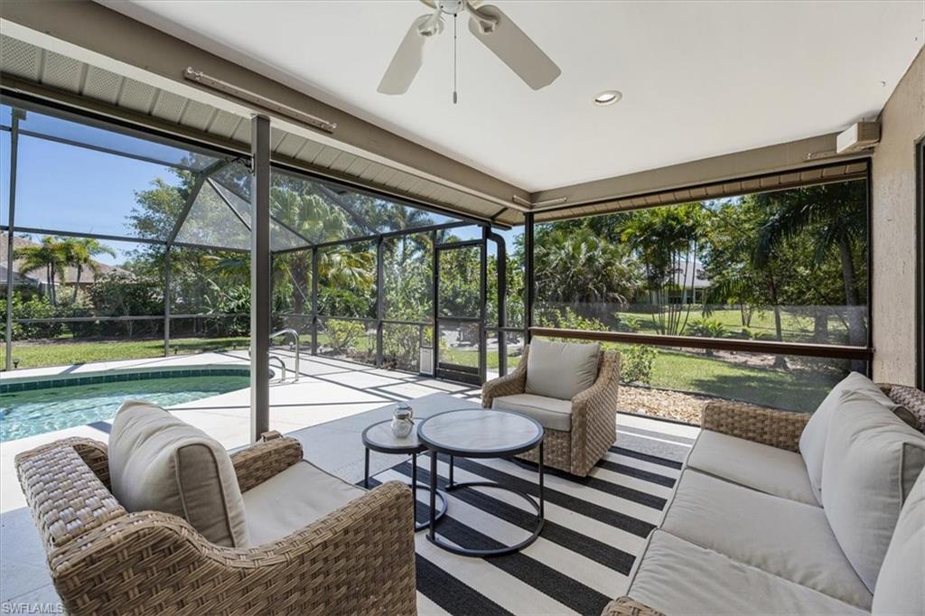 136 Old Tamiami Trail Naples, FL 34110 - Photo 18 of 24 a living room with furniture and a floor to ceiling window