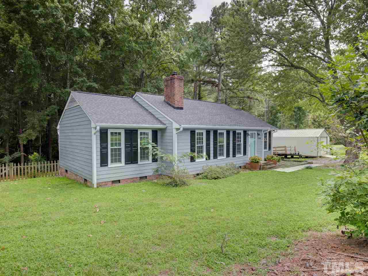 5509 Farmridge Road Raleigh, NC 27617 - Photo 22 of 23 a view of a house with a yard and sitting area