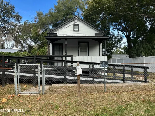 a front view of a house with wooden fence