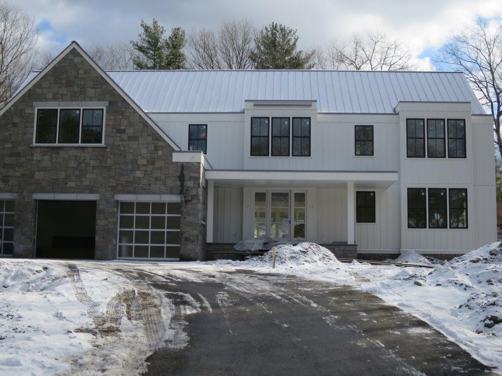 49 Falmouth Road Wellesley, MA 02481 - Photo 1 of 5 a front view of a house with a yard