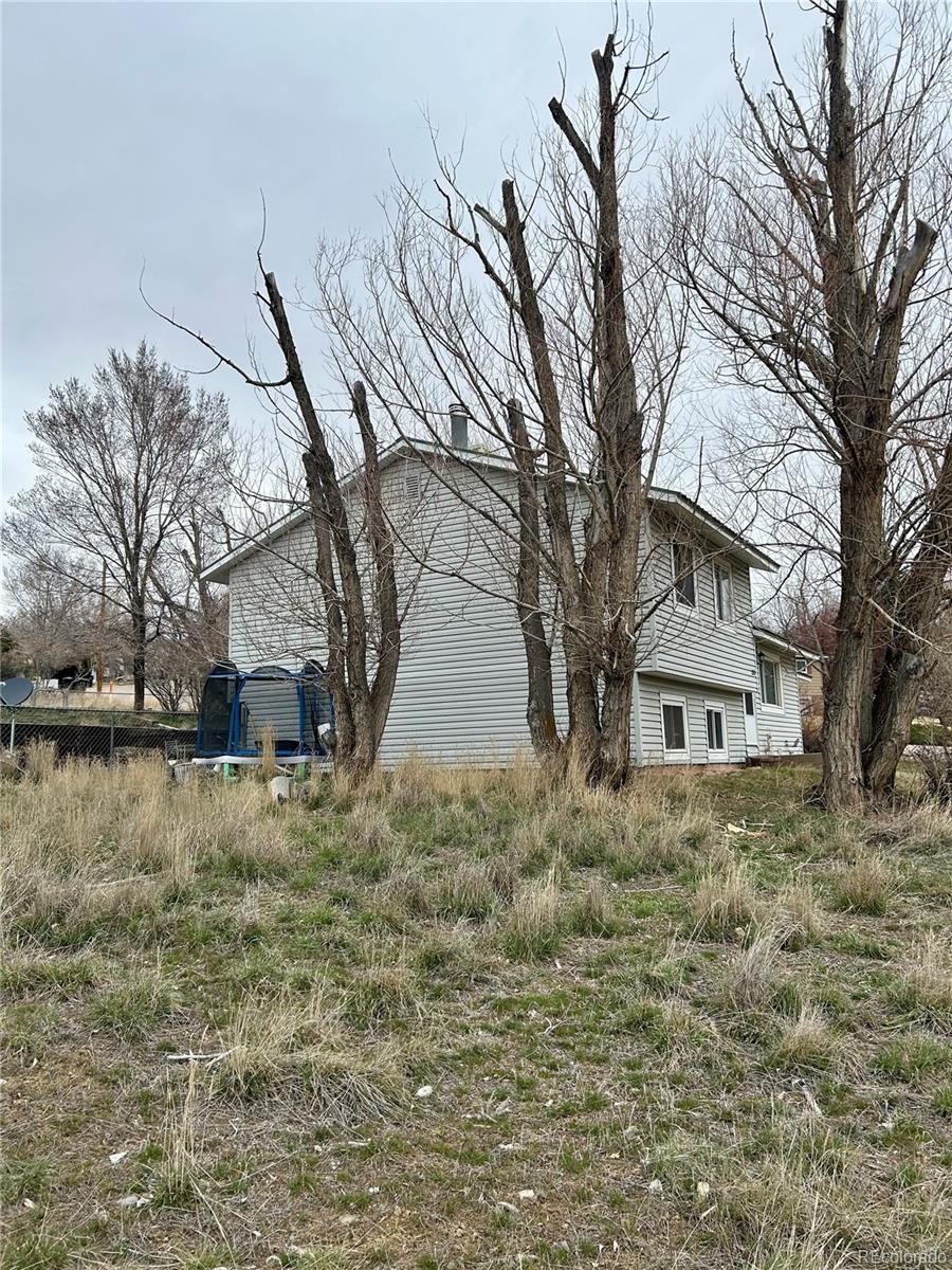 730 Ashley Road Craig, CO 81625 - Photo 39 of 43 a white house that has a tree in front of it