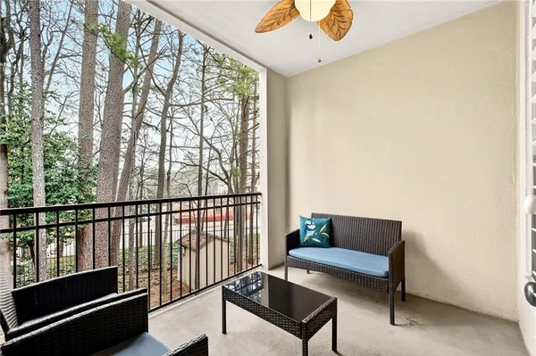 a living room with furniture and a floor to ceiling window