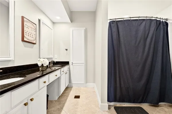 a kitchen with granite countertop a refrigerator and a sink