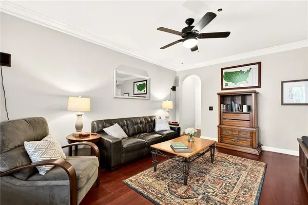 a living room with furniture and a wooden floor