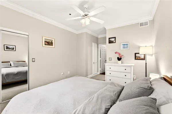 a bedroom with a bed and ceiling fan
