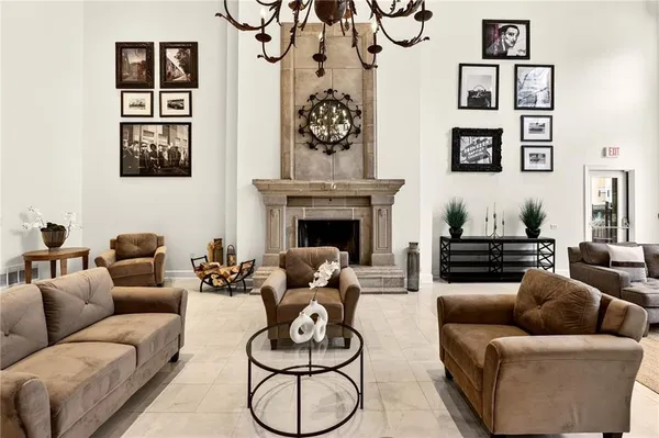 a living room with furniture a fireplace and wall paintings
