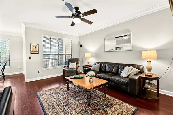 a living room with furniture and a wooden floor