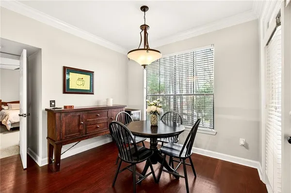 a view of a dining room with furniture window and wooden floor