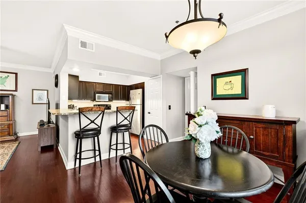 a dining room with furniture and wooden floor