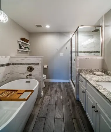 a spacious bathroom with a granite countertop sink and a mirror
