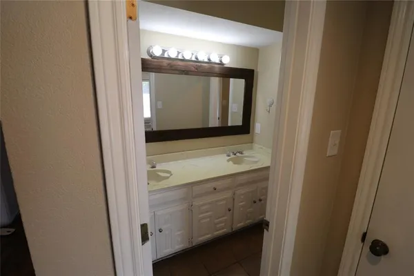a bathroom with a double vanity sink and mirror