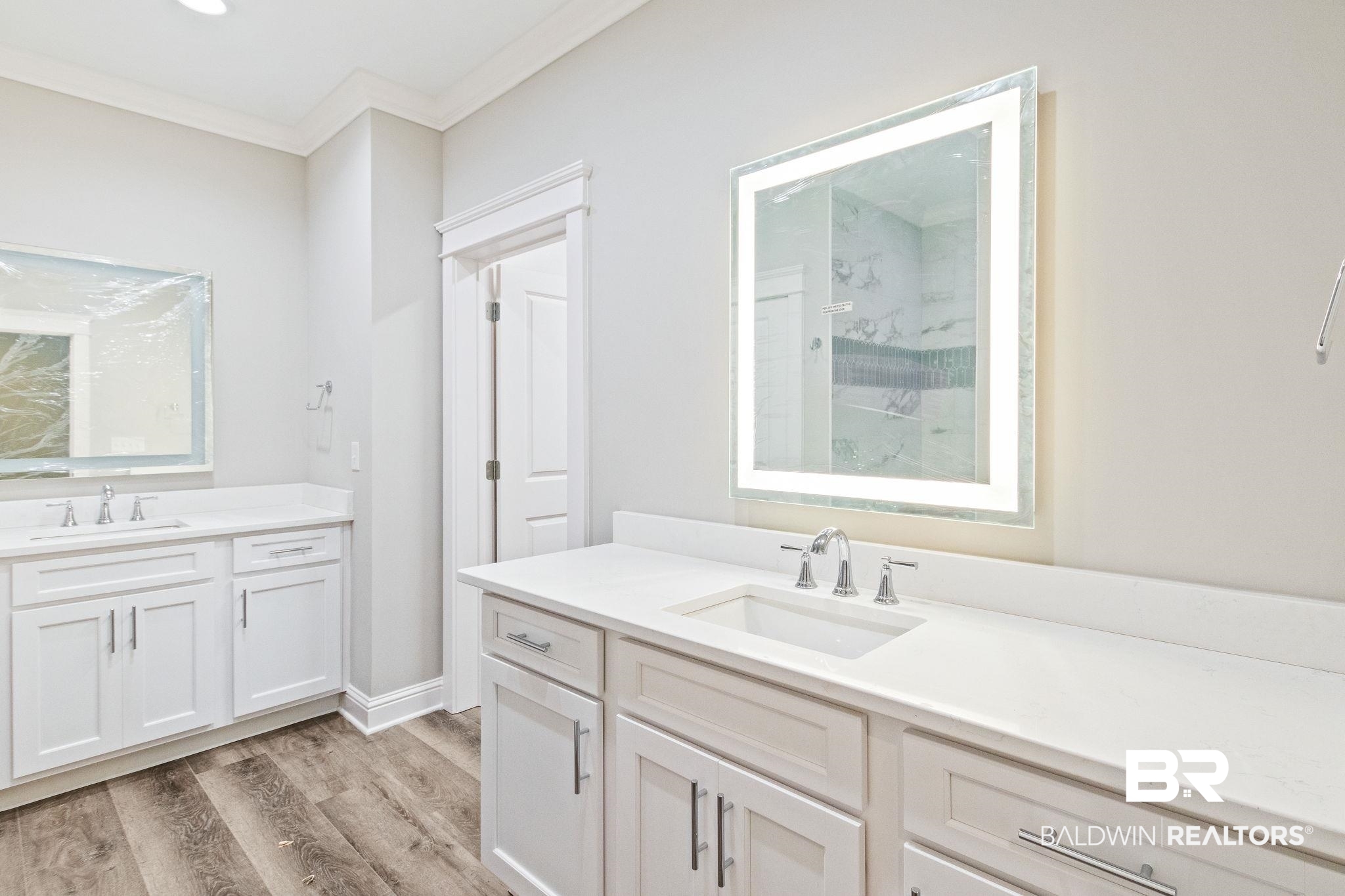 12441 Reunion Place Foley, AL 36535 - Photo 15 of 31 Bathroom featuring crown molding, vanity, and hardwood / wood-style flooring