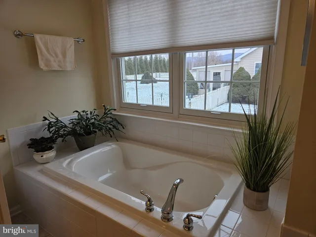 a bath room with a sink and a large window