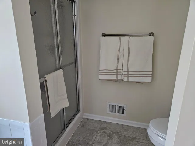 a bathroom with a toilet and a shower