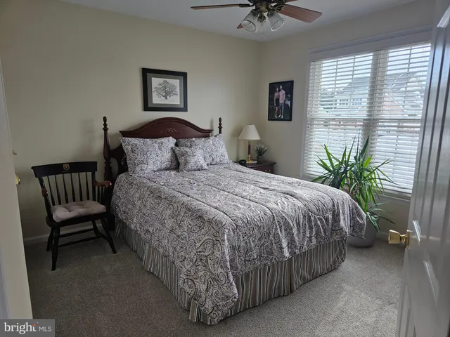 a large bed sitting in a bedroom next to a window