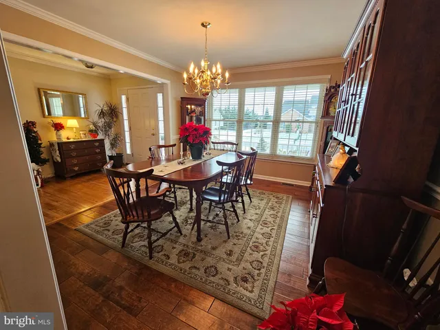 a view of a dining room with furniture and a chandelier