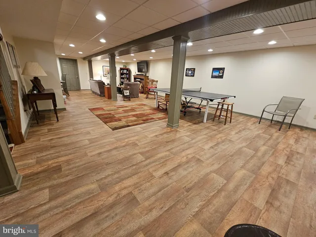 a room with lots of chairs and couches with kitchen view