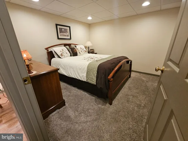 a bedroom with a bed and a mirror