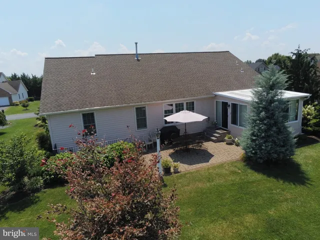 a front view of house with yard and trees