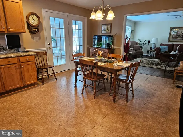 a view of a dining room with furniture and a chandelier