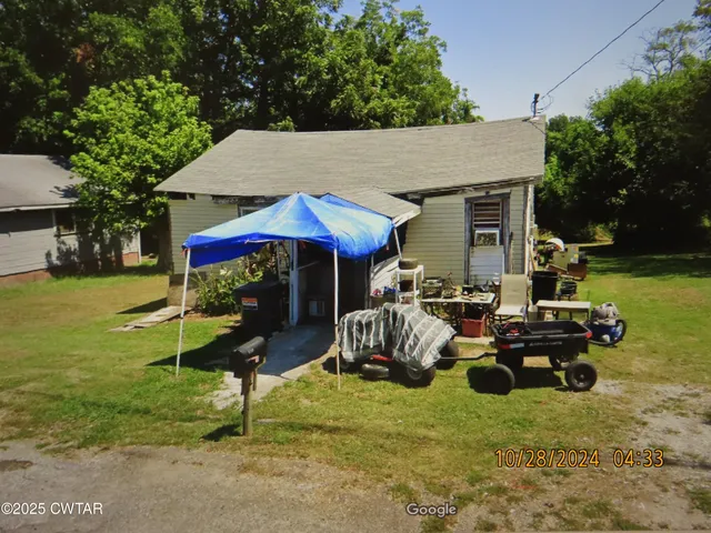 a view of a house with backyard porch and sitting area