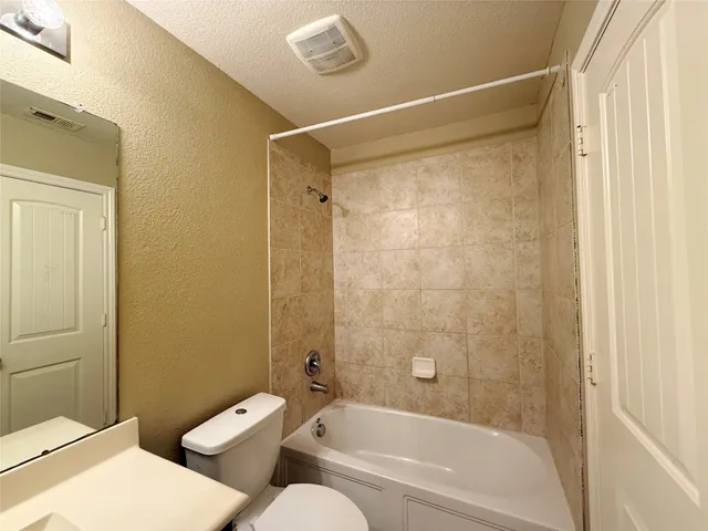 a bathroom with a toilet and a bathtub