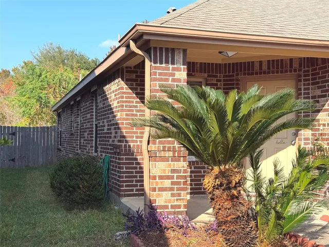 a view of a house with a flower garden