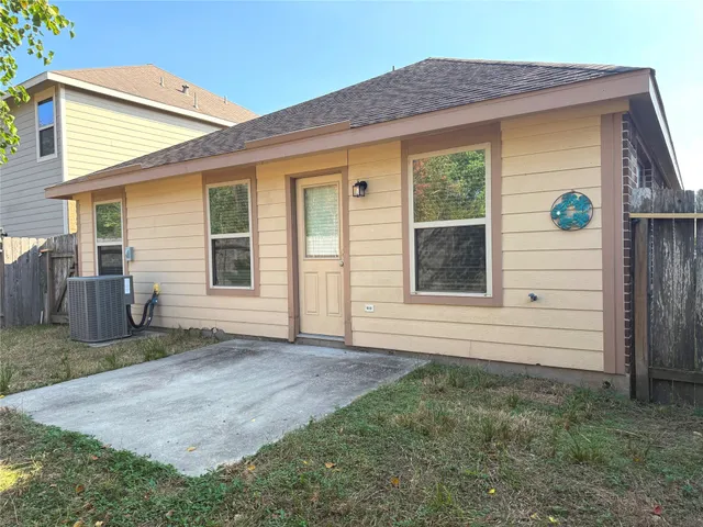 a view of house with backyard