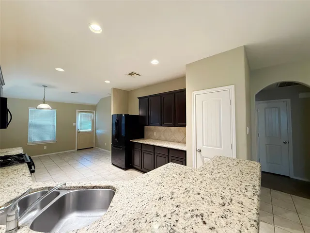 a kitchen with a sink and a refrigerator