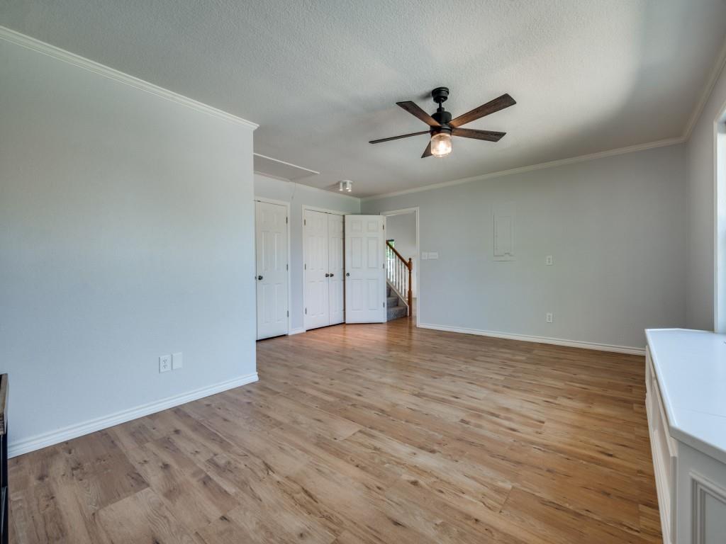 401 North Sierra Trail Pilot Point, TX 76258 - Photo 16 of 30 an empty room with wooden floor ceiling fan and windows