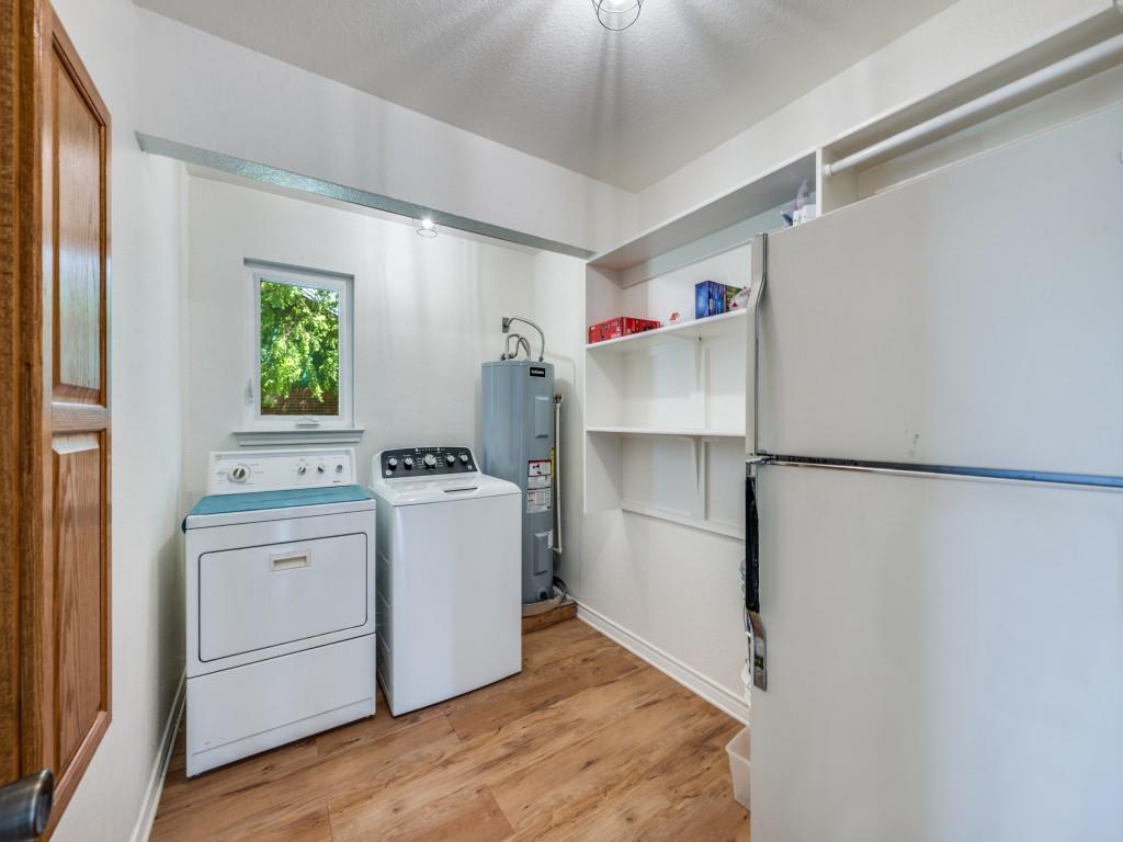 401 North Sierra Trail Pilot Point, TX 76258 - Photo 18 of 30 a kitchen with a refrigerator and white cabinets