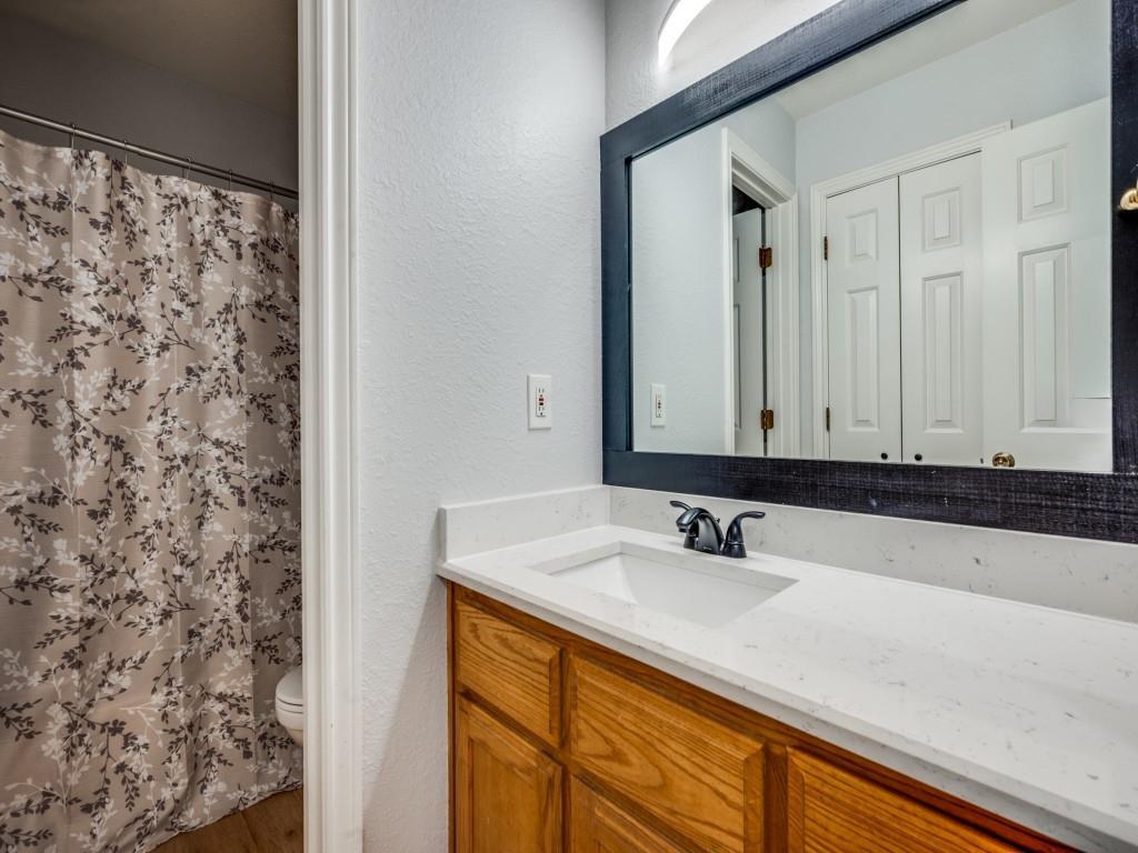401 North Sierra Trail Pilot Point, TX 76258 - Photo 23 of 30 a bathroom with a sink and a mirror