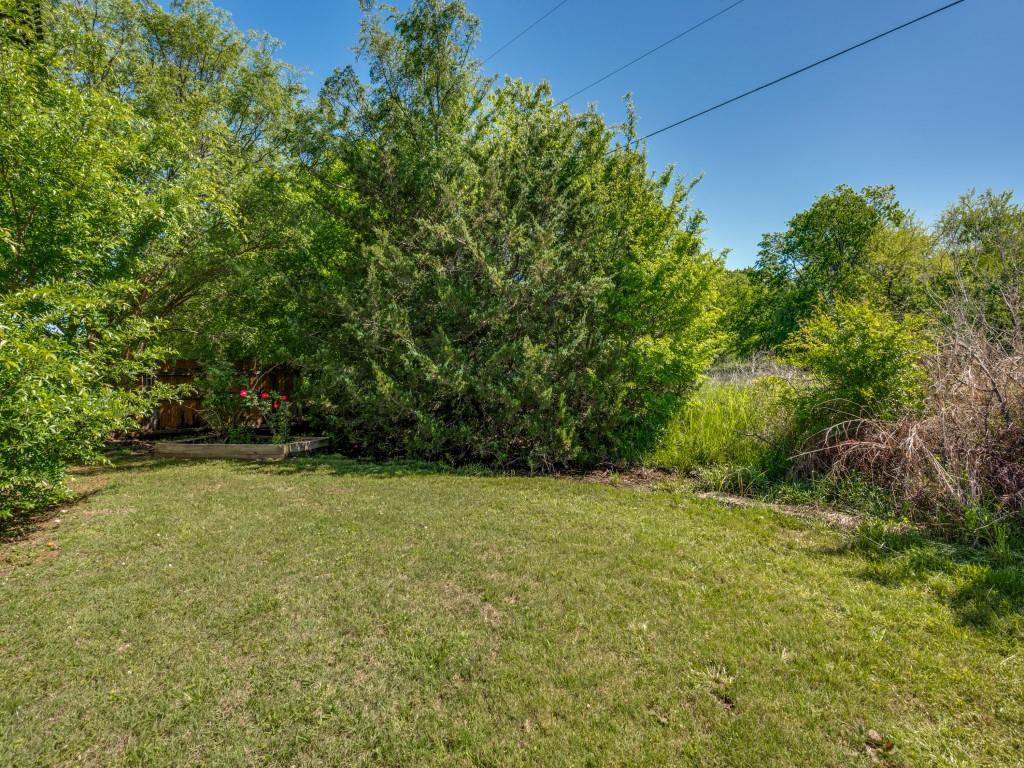 401 North Sierra Trail Pilot Point, TX 76258 - Photo 27 of 30 a view of a field with trees in front of it