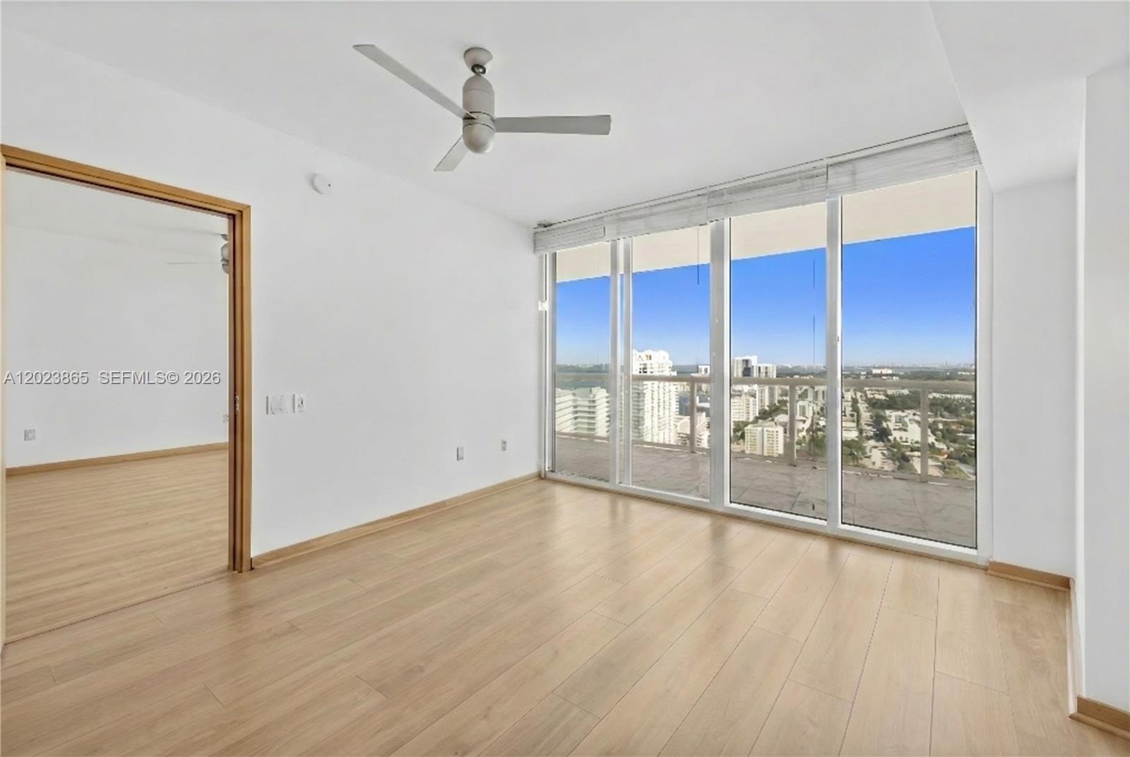 450 Alton Road, Unit 3206 Miami Beach, FL 33139 - Photo 15 of 25 a view of a kitchen with wooden floor and a glass door