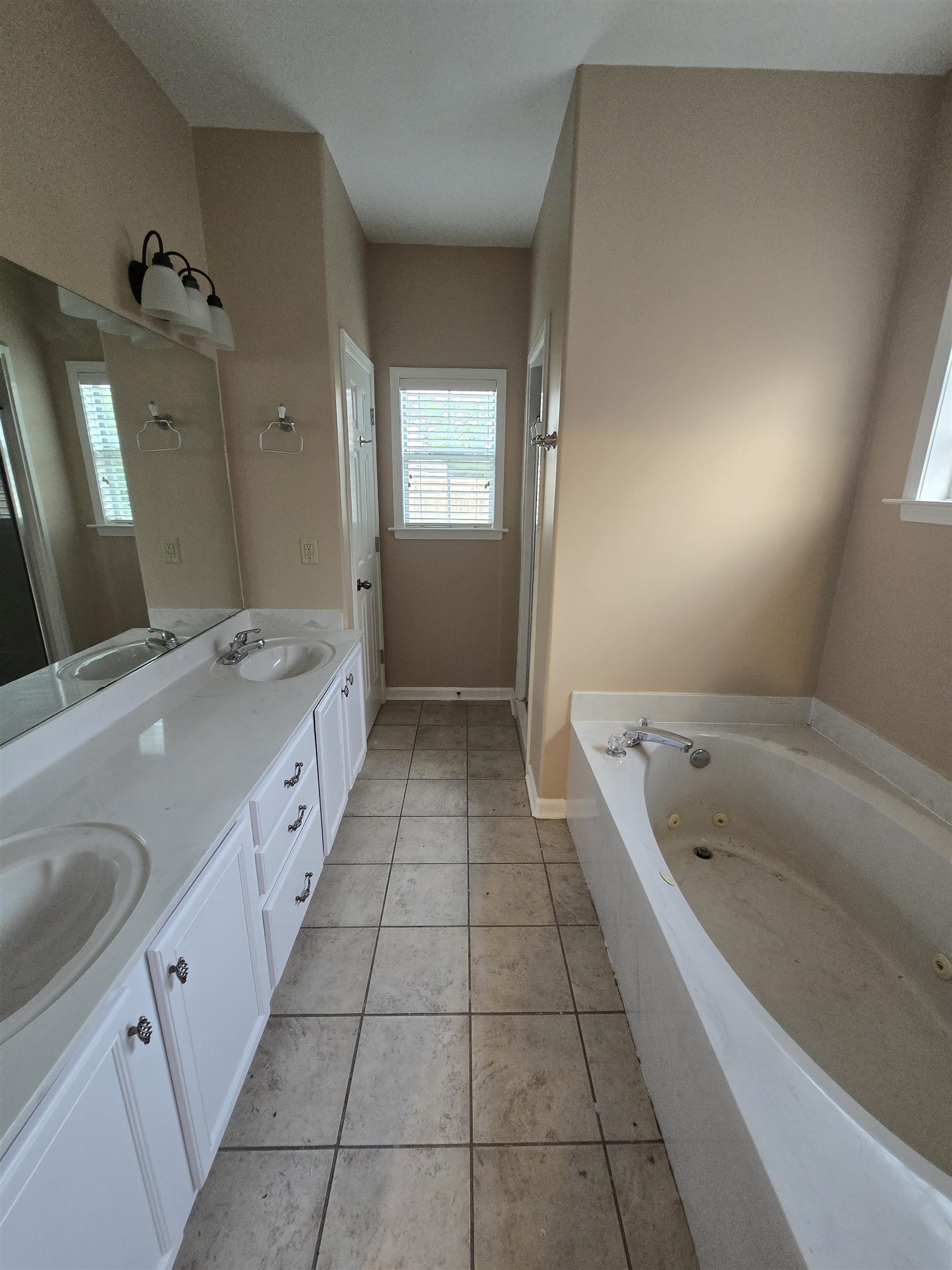 5186 Guffin Road Bartlett, TN 38135 - Photo 11 of 21 a spacious bathroom with a granite countertop sink a toilet a mirror and bathtub