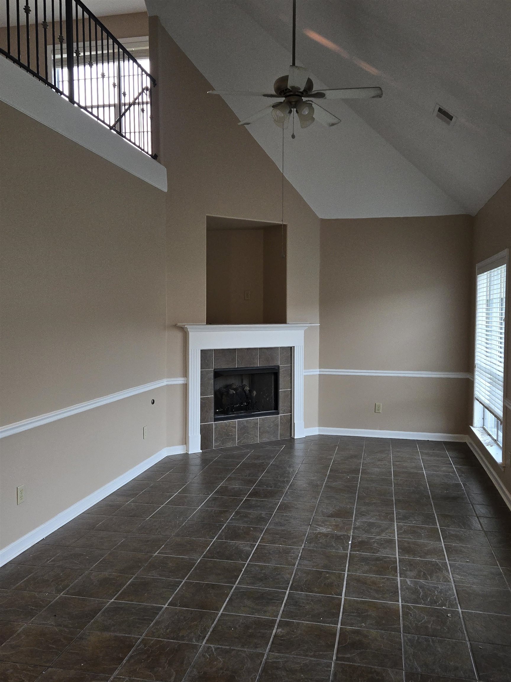 5186 Guffin Road Bartlett, TN 38135 - Photo 7 of 21 a view of an empty room with a fireplace and a window