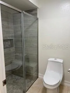 a bathroom with a toilet and a shower