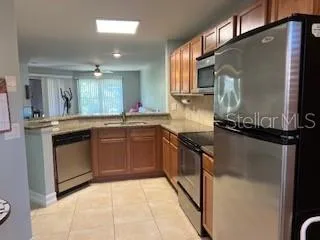 a kitchen with granite countertop a sink and stainless steel appliances
