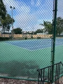 a view of a yard and wooden fence