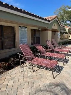 a backyard of a house with lots of green space and outdoor seating