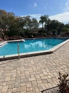 a view of a swimming pool with a table and chairs