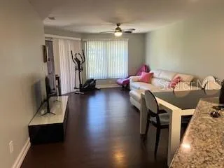 a view of a workspace with furniture and wooden floor