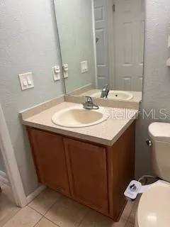 a bathroom with a sink toilet and mirror