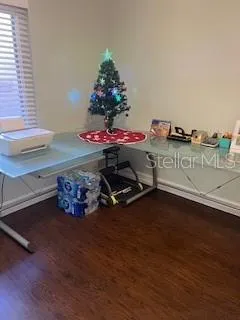 a room with wooden floor and shoes