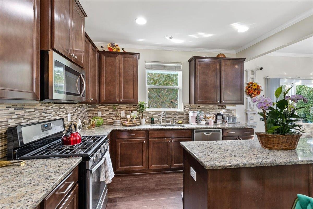 3537 Massey Ridge Court Raleigh, NC 27616 - Photo 12 of 41 a kitchen with stainless steel appliances granite countertop a sink stove and cabinets