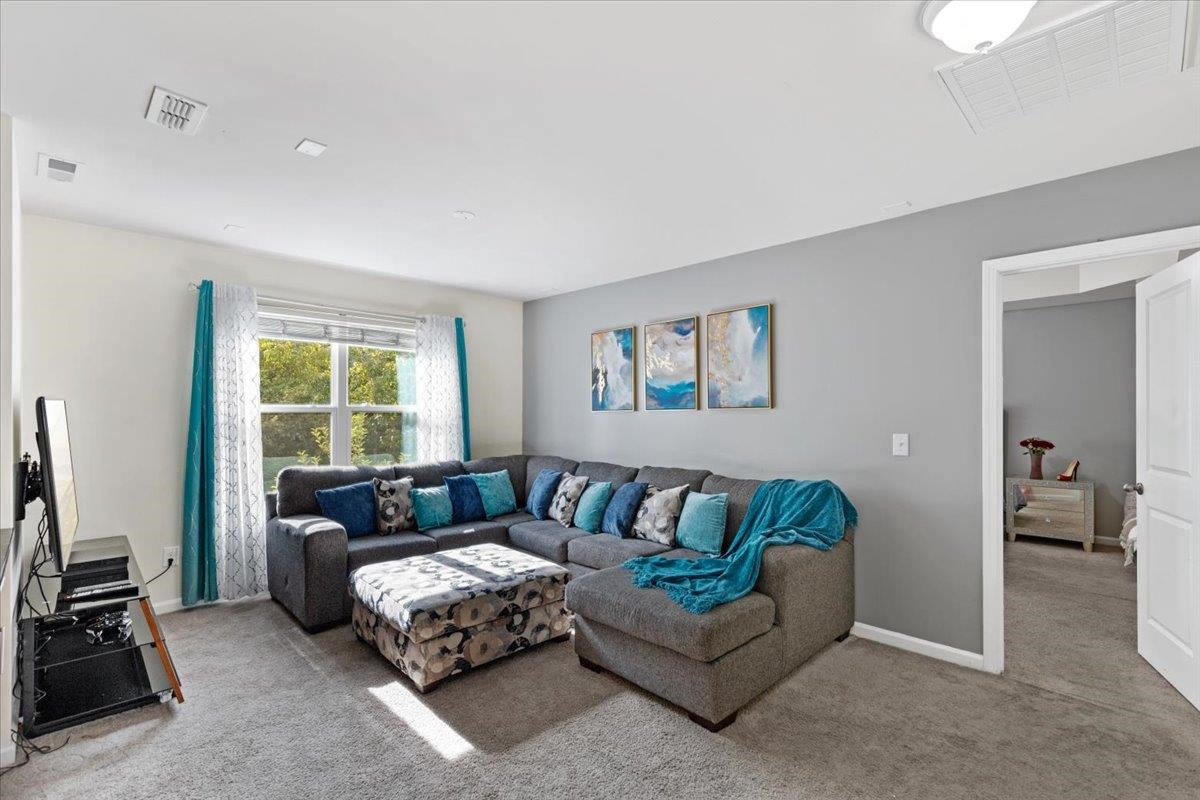 3537 Massey Ridge Court Raleigh, NC 27616 - Photo 21 of 41 a living room with furniture and a flat screen tv