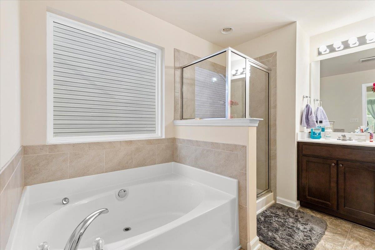 3537 Massey Ridge Court Raleigh, NC 27616 - Photo 27 of 41 a bathroom with a bathtub and a sink