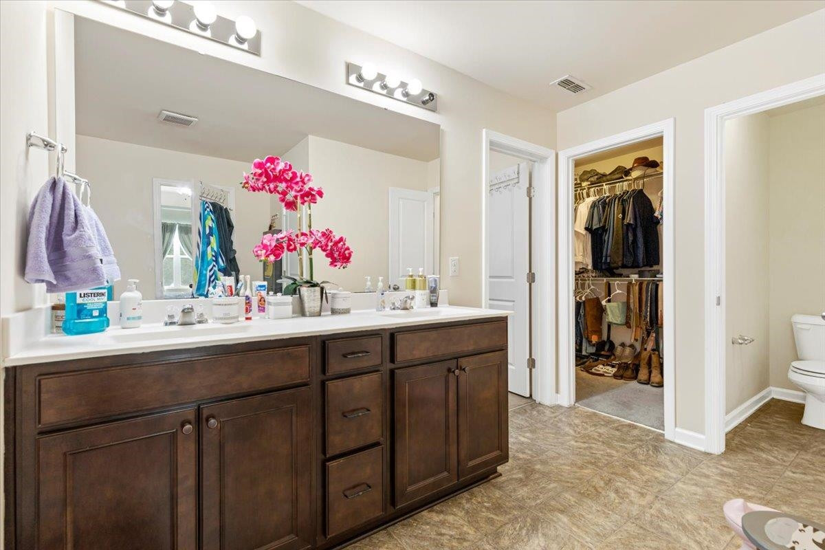 3537 Massey Ridge Court Raleigh, NC 27616 - Photo 28 of 41 a bathroom with a sink vanity and a mirror