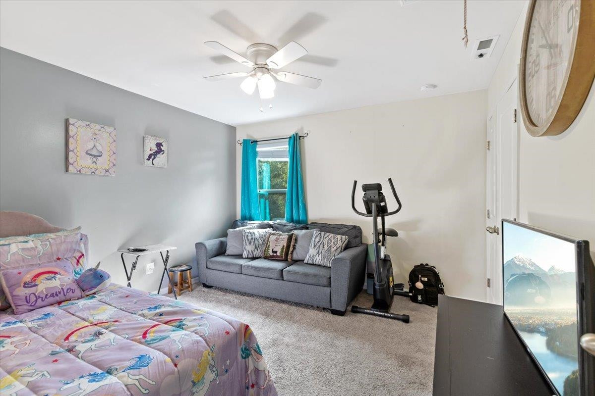 3537 Massey Ridge Court Raleigh, NC 27616 - Photo 30 of 41 a bedroom with bed and a chandelier