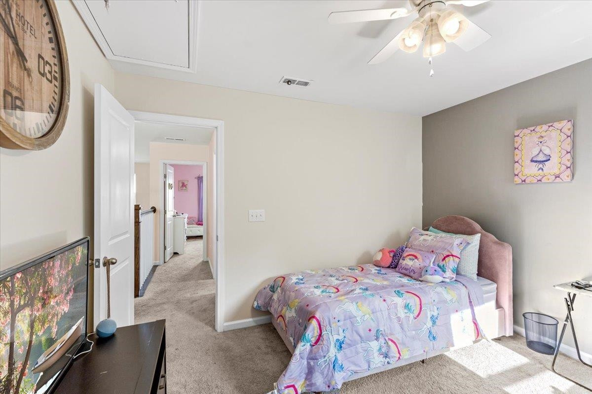 3537 Massey Ridge Court Raleigh, NC 27616 - Photo 31 of 41 a bedroom with a bed and a chandelier